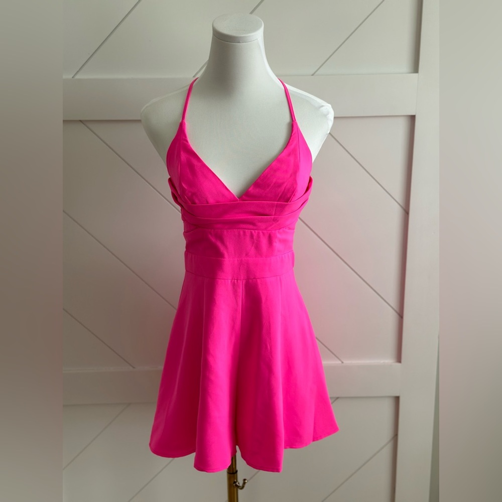 Bright pink flowy shorts romper that ties up the back